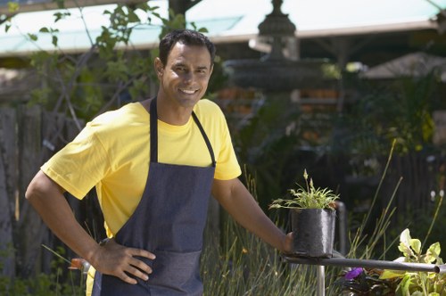 Gardener using hedge trimmers professionally